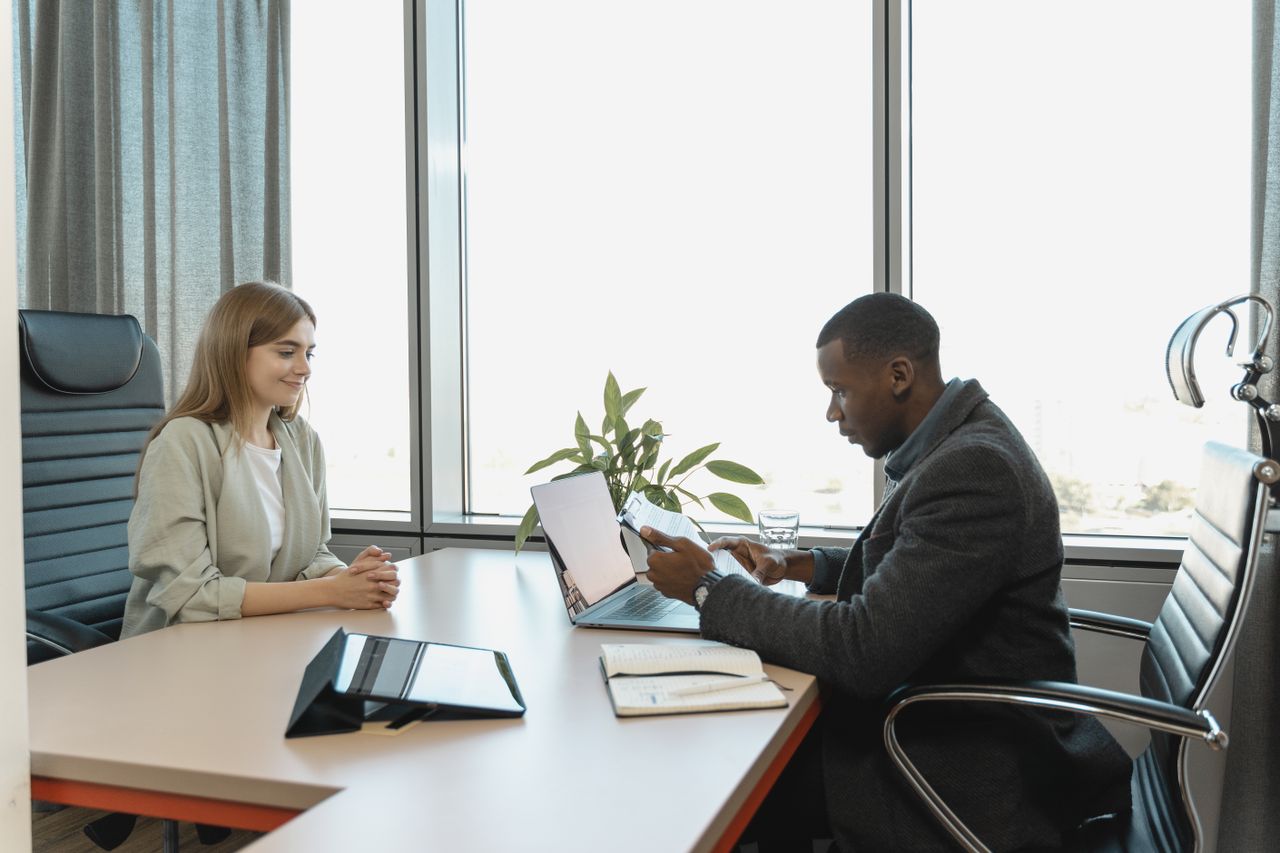 The Art of Drawing Readers In: Your attractive post title goes here Business meeting with diverse professionals discussing a job opportunity.
